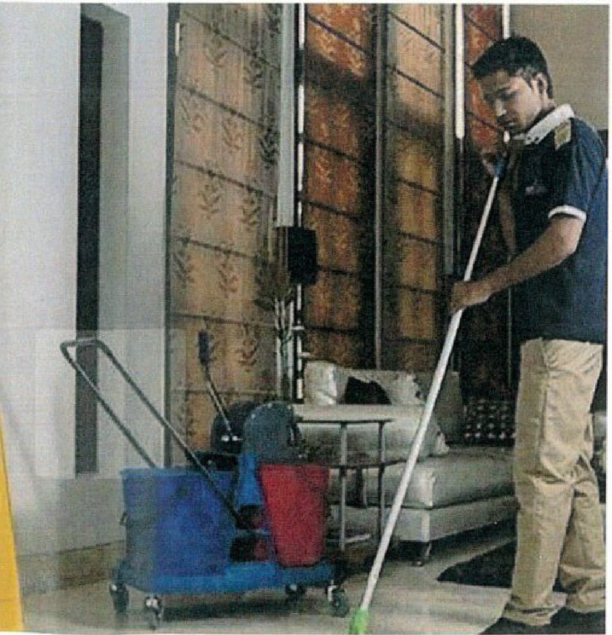 A Force housekeeping staff cleaning inside commercial building