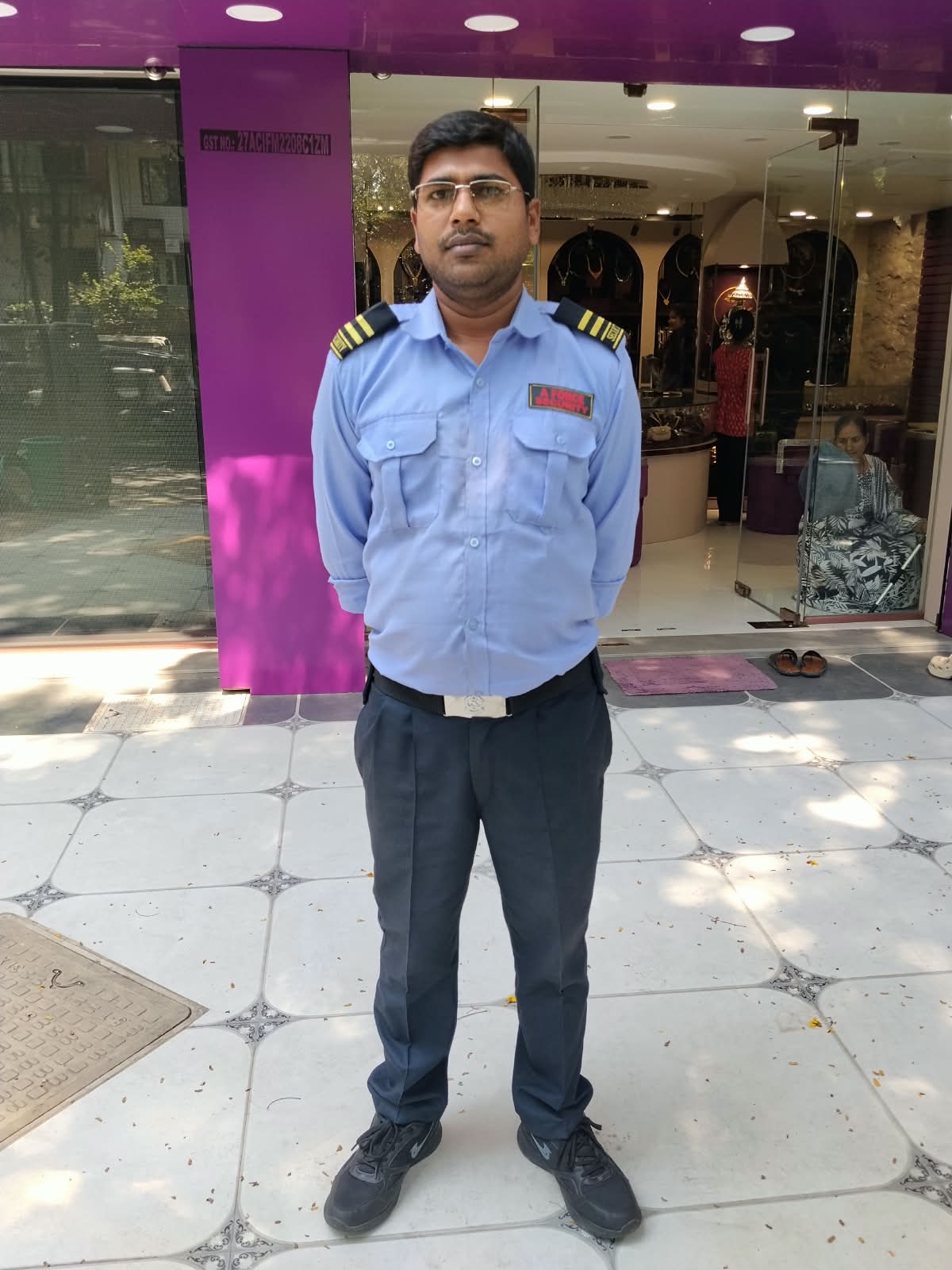 A Force Security guard standing outside shop